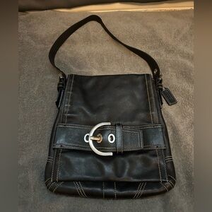 vintage Coach Soho black leather shoulder bag with silver-tone buckle detail.